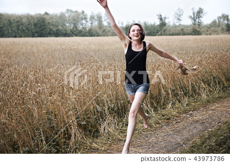 young girl posing on the country road and field young girl posing on the country road and field 43973786