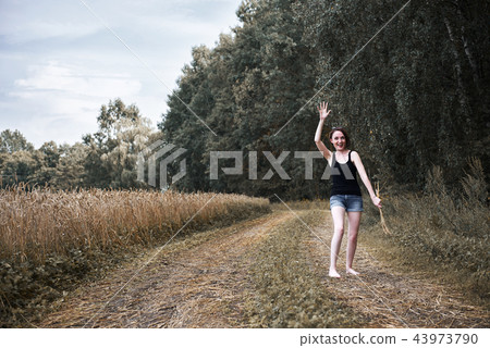 young girl posing on the country road and field young girl posing on the country road and field 43973790