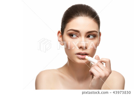 girl applying pink lipstick isolated on white girl applying pink lipstick isolated on white 43973830