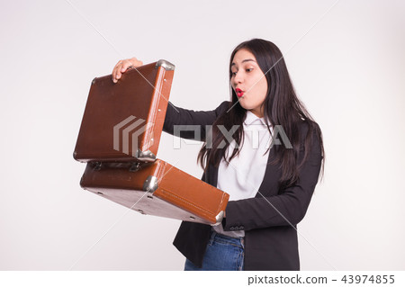 Asian young woman with red lipstick looking into a suitcase Asian young woman with red lipstick looking into a suitcase 43974855