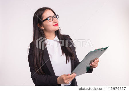 Business, work and people concept - Asian young woman holding a folder Business, work and people concept - Asian young woman holding a folder 43974857