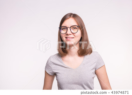 Young beautiful woman in glasses over white background with copy space Young beautiful woman in glasses over white background with copy space 43974871