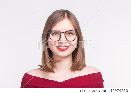 Portrait of beautiful caucasian young woman with red lips and glasses over white background Portrait of beautiful caucasian young woman with red lips and glasses over white background 43974880