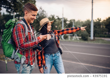 Couple of tourists looking for city attractions Couple of tourists looking for city attractions 43975191