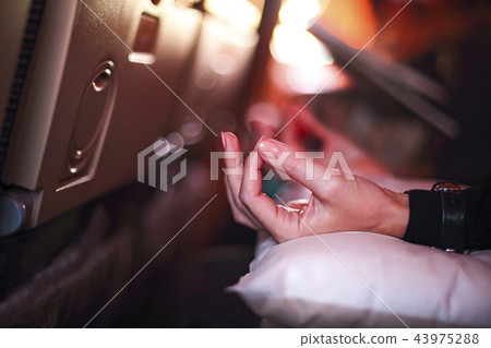 Person meditating in the plane 43975288