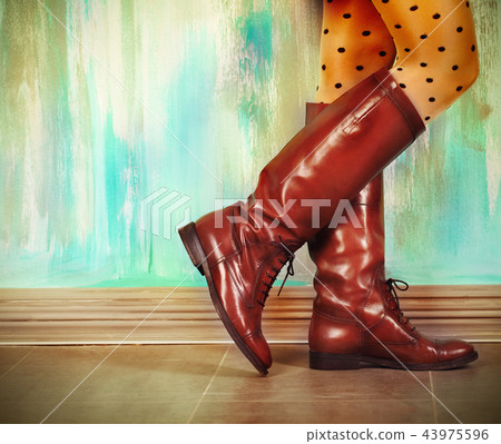 Female legs in high brown leather boots 43975596