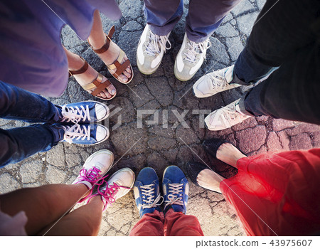 Group of friends with their legs in a circle Group of friends with their legs in a circle 43975607