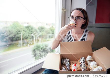 girl eating tasty cakes, sweet food and pleasure 43975722