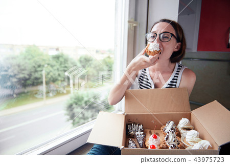 girl eating tasty cakes, sweet food and pleasure 43975723