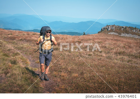 Alone tourist hiking in the mountains Alone tourist hiking in the mountains 43976401