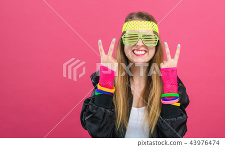 Woman in 1980's fashion giving the peace sign 43976474