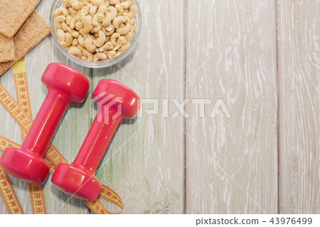 The concept of a healthy diet. Small dumbbells The concept of a healthy diet. Small dumbbells 43976499