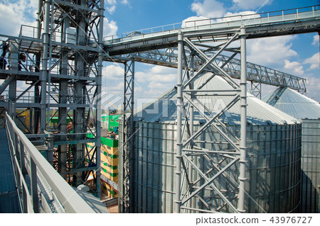 Modern silos for storing grain harvest. Agriculture. Background. Modern silos for storing grain harvest. Agriculture. Background. 43976727