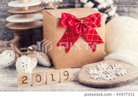 Craft gift box, red bow, wooden christmas trees Craft gift box, red bow, wooden christmas trees 43977331