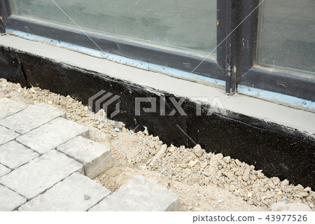 Waterproofing house foundation with spray on tar Waterproofing house foundation with spray on tar 43977526