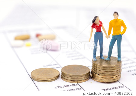 Miniature couple people and stack coins Miniature couple people and stack coins 43982162