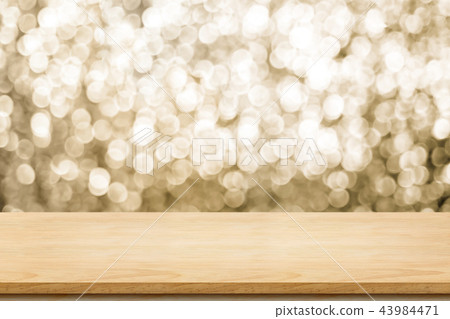 Empty old rustic wood table with sparkling gold Empty old rustic wood table with sparkling gold 43984471