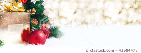 gift box and ball decoration under christmas tree 43984475