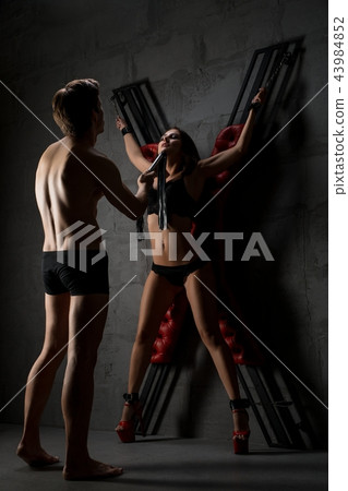 Sexy lovers perfoming erotic bdsm play shot 43984852