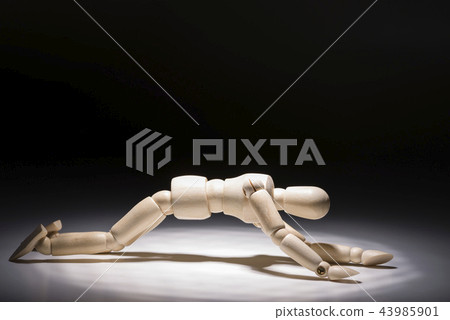 Fallen wooden doll 43985901