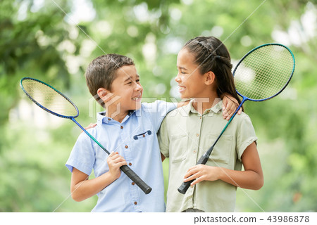 Cheerful siblings after badminton game Cheerful siblings after badminton game 43986878