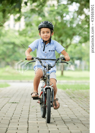 Boy riding bicycle 43986901