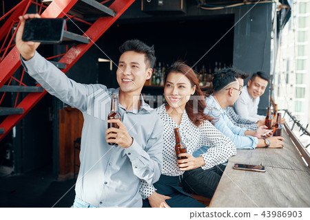 Coworkers taking selfie 43986903
