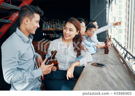 Young Asian couple flirting in bar Young Asian couple flirting in bar 43986905
