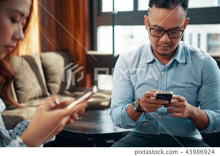 Texting colleagues Texting colleagues 43986924