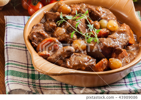 Beef Bourguignon stew served with baguette Beef Bourguignon stew served with baguette 43989086