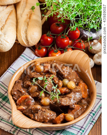 Beef Bourguignon stew served with baguette Beef Bourguignon stew served with baguette 43989087