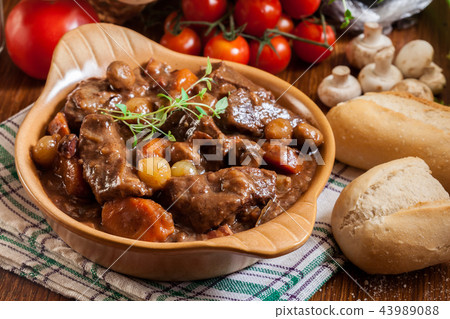 Beef Bourguignon stew served with baguette Beef Bourguignon stew served with baguette 43989088