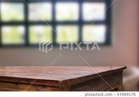 Wooden board empty table space platform in front of blurred Livi 43989176