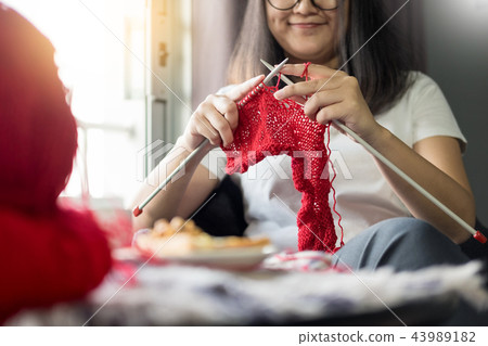 young woman hands knitting warm sweaters. Sitting on old arm young woman hands knitting warm sweaters. Sitting on old arm 43989182