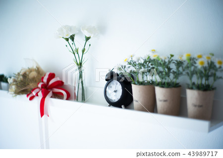 Vintage alarm clock puts on the white shelf 43989717