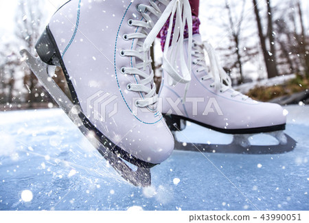 Close-up of woman ice skating on a pond. 43990051