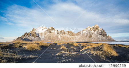Vestrahorn mountains with a blue sky with clouds, Iceland Vestrahorn mountains with a blue sky with clouds, Iceland 43990269