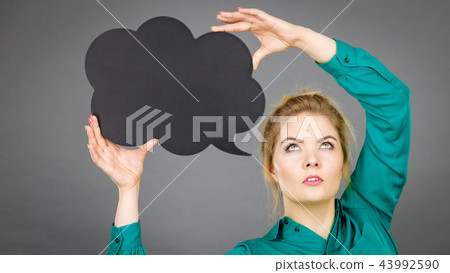 Woman holding black thinking bubble Woman holding black thinking bubble 43992590