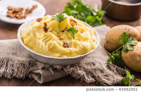 Mashed potatoes in bowl with parsley herbs. Mashed potatoes in bowl with parsley herbs. 43992891