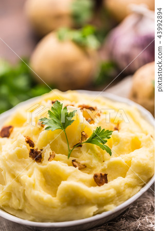 Mashed potatoes in bowl with parsley herbs. Mashed potatoes in bowl with parsley herbs. 43992894