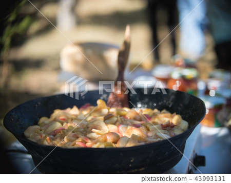 Fried apples in a cast-iron black frying pan Fried apples in a cast-iron black frying pan 43993131