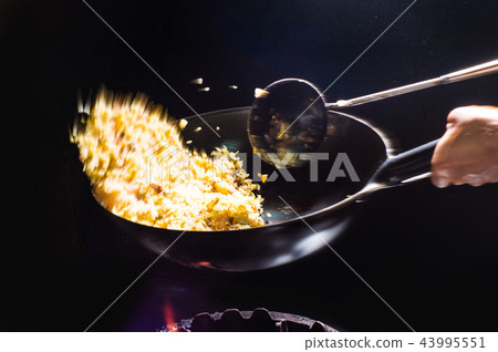 Cooking fried rice in a wok Cooking fried rice in a wok 43995551