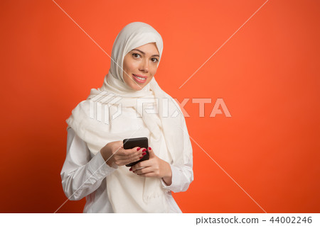 Happy arab woman in hijab. Portrait of smiling girl, posing at studio background 44002246