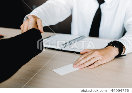 Business people passing blank business card Business people passing blank business card 44004776