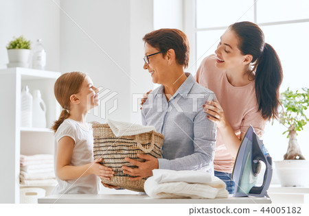 family doing laundry at home family doing laundry at home 44005182