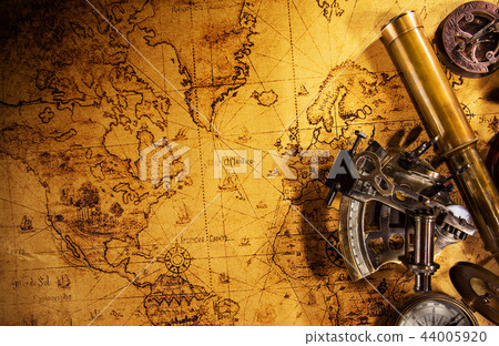Old vintage navigation equipment on old world map. 44005920