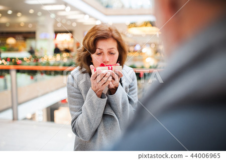 Senior couple with present doing Christmas shopping. 44006965