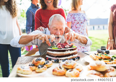 Family celebration or a garden party outside in the backyard. Family celebration or a garden party outside in the backyard. 44007011