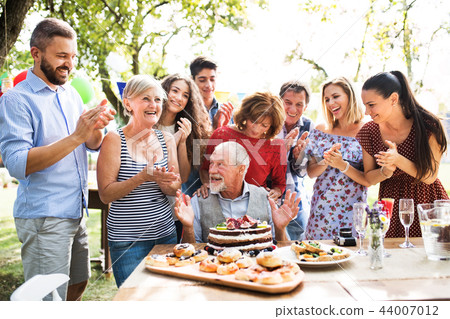 Family celebration or a garden party outside in the backyard. Family celebration or a garden party outside in the backyard. 44007012