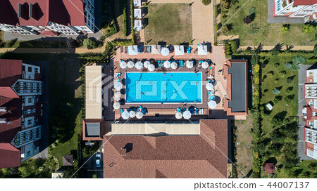 Aerial view on people in swimming pool. Top view of people sunbathing pool. Aerial view on people in swimming pool. Top view of people sunbathing pool. 44007137